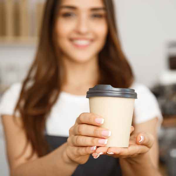 Server handing coffee drink with a smile